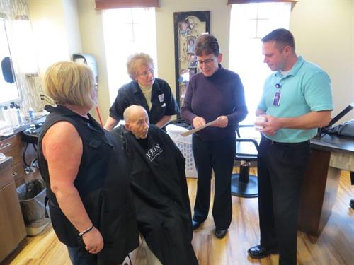 Larson Employees Present Gift Cards to The Neighborhoods Larson Employees raise funds for assisted living center